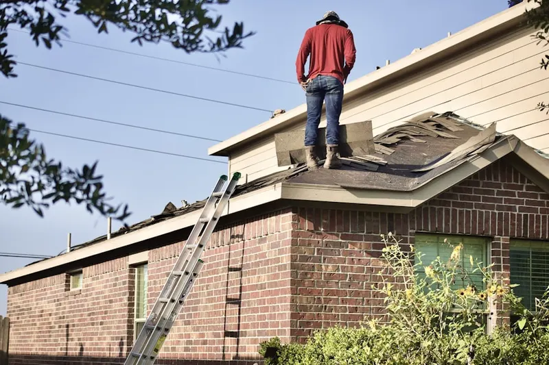 Professional roofer working on a residential roof in Atascocita
